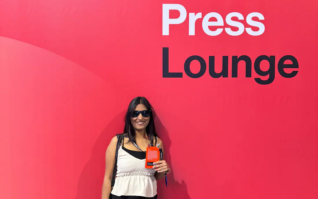 Shilika Jain in front of a red Press Lounge wall at the Consensus conference