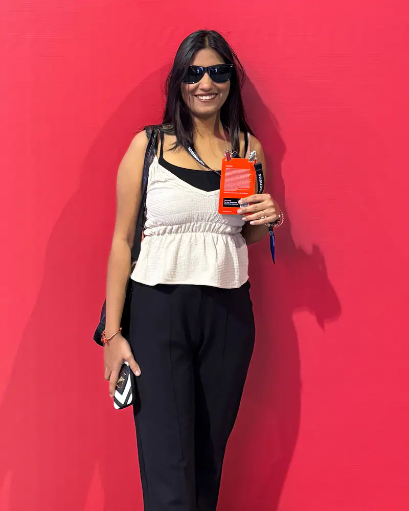 Shilika Jain in front of a red Press Lounge wall at the Consensus conference