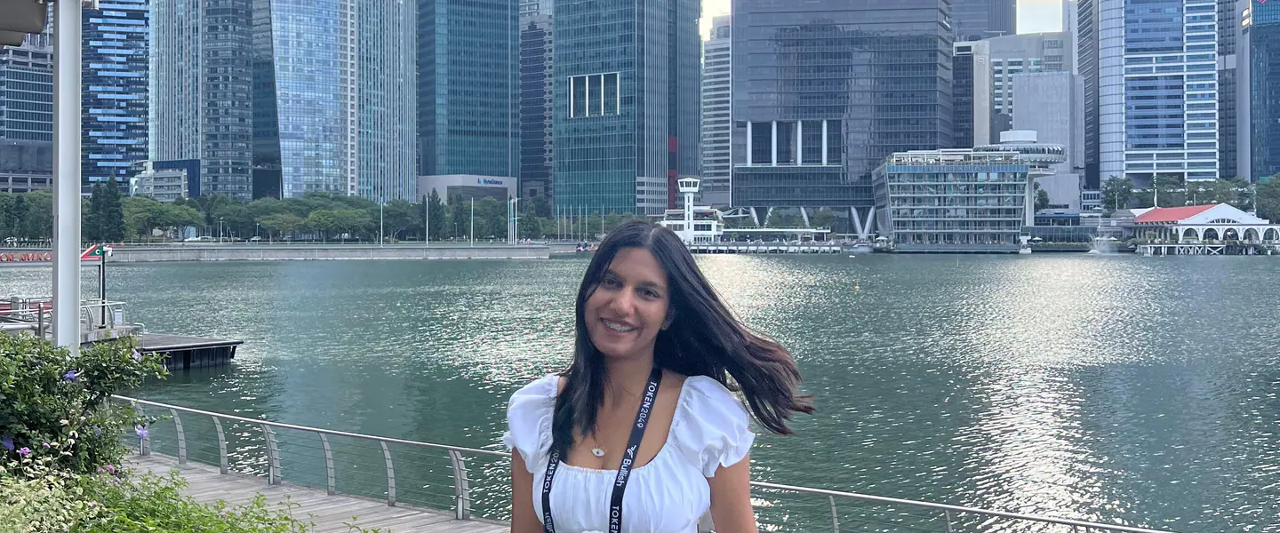 Shilika Jain at the Marina Bay railing with the Singapore financial district skyline behind her