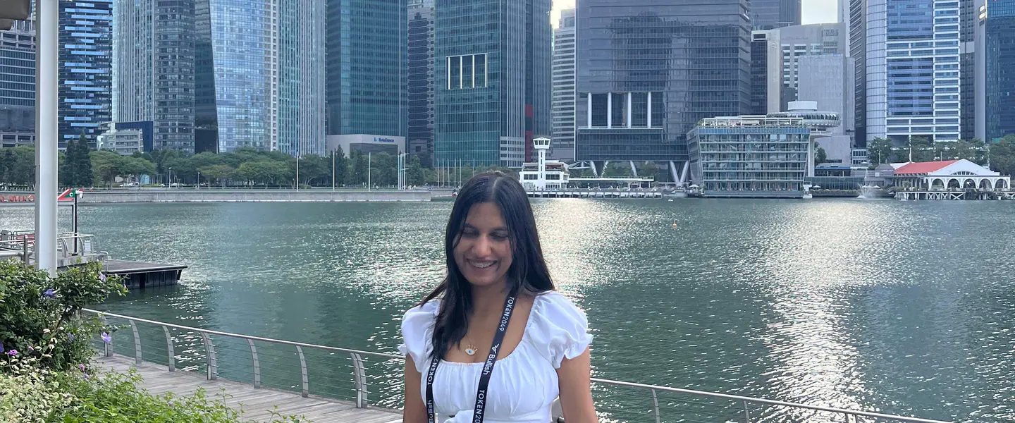 Shilika Jain smiling at the Marina Bay railing against the Singapore skyline