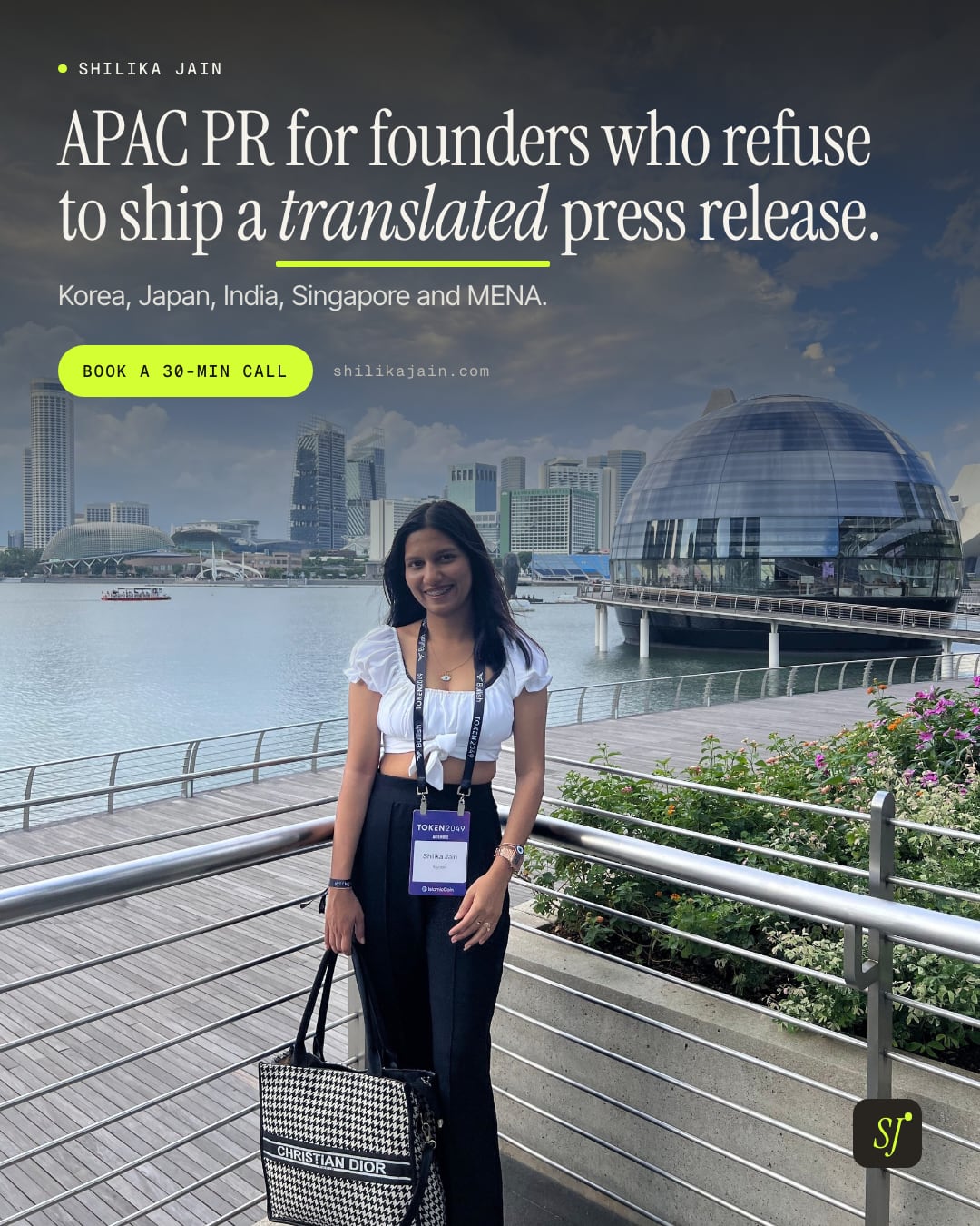 APAC PR for founders who refuse to ship a translated press release. Korea, Japan, India, Singapore and MENA. Photo: Shilika Jain wearing a conference badge on the Marina Bay promenade in Singapore.