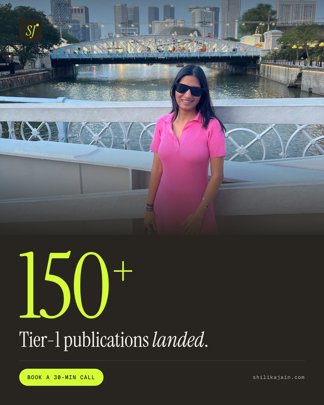 150+ Tier-1 publications landed. Photo: Shilika Jain in a pink dress and sunglasses on the Singapore River at dusk.