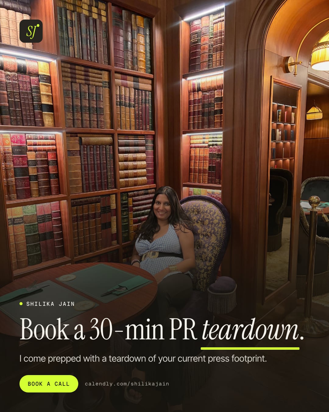 Book a 30-min PR teardown. I come prepped with a teardown of your current press footprint. Photo: Shilika Jain seated in a wood-panelled library lounge lined with leather-bound books.