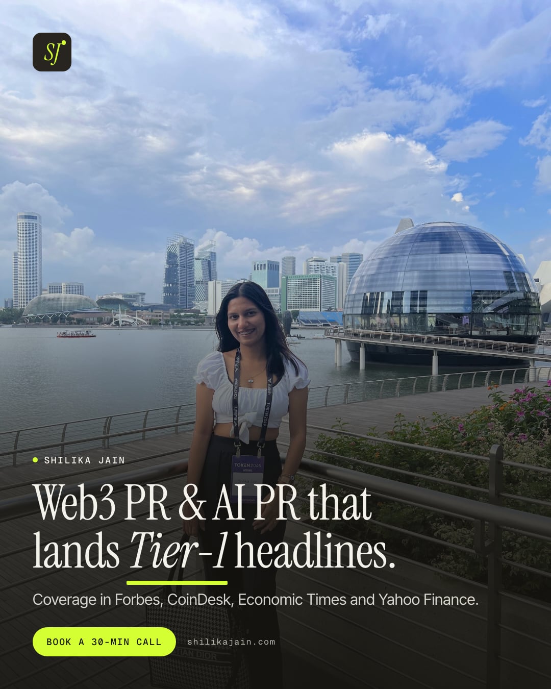 Web3 PR & AI PR that lands Tier-1 headlines. Coverage in Forbes, CoinDesk, Economic Times and Yahoo Finance. Photo: Shilika Jain wearing a conference badge on the Marina Bay promenade in Singapore.